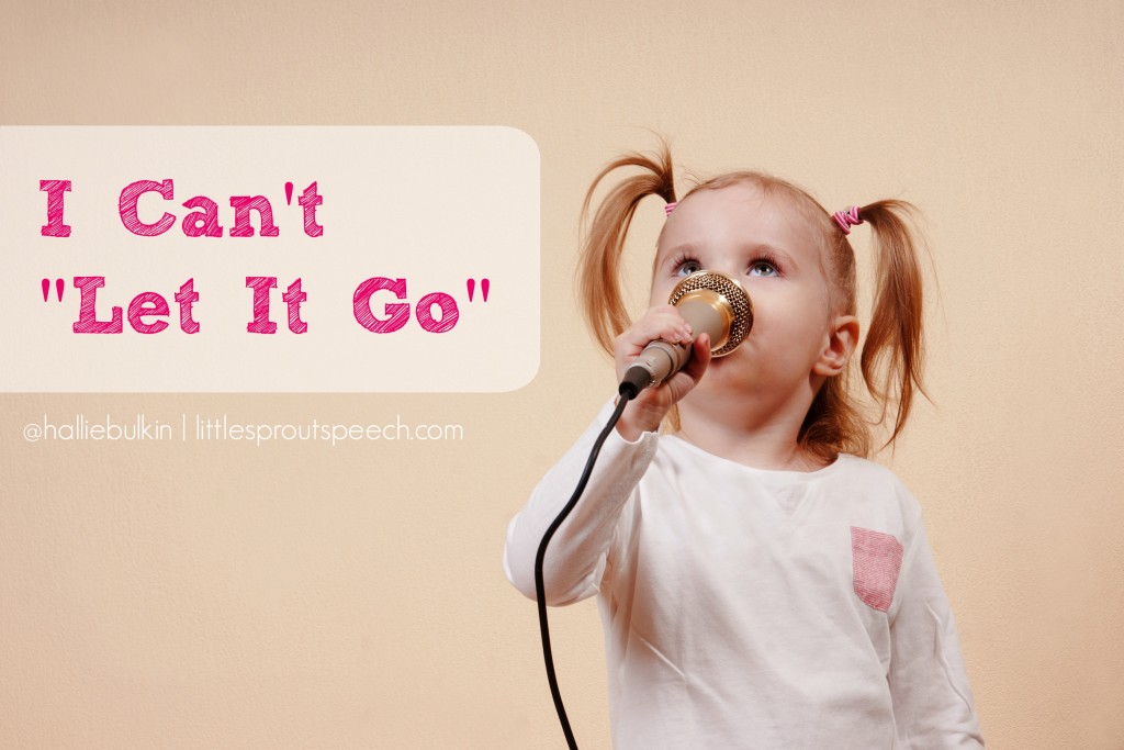 Little girl holding microphone and singing, horizontal studio shot